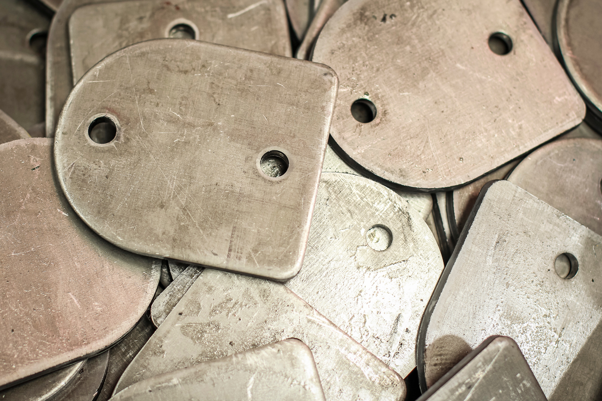 Close-up of worker using industrial press in metalworking process